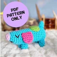 a small crocheted elephant toy with a pink circle over it's head