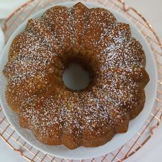 a bundt cake sitting on top of a white plate covered in powdered sugar