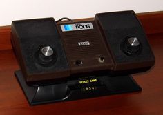 two brown speakers sitting on top of a wooden table