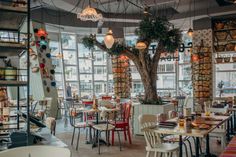 the interior of a restaurant with many tables and chairs