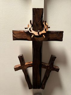 a wooden cross hanging from the side of a wall