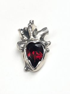 "Sterling silver anatomical heart with a gorgeous deep red garnet.  This pendant comes on an 18\" silver chain. Made to order. Please expect 1-2 weeks processing time." Anatomical Heart Pendant, Anatomical Jewelry, Red Gemstone Jewelry, Alt Clothes, Anatomical Heart, Chatelaine, Jewelry Inspo, Red Garnet, Piercing Jewelry