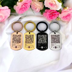 four different styles of key chains with qr code on them and flowers in the background