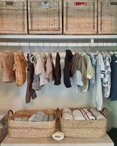 the closet is organized with baskets and clothes