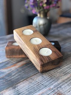 two wooden candles sitting on top of a table