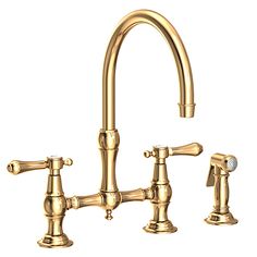 a golden faucet with two handles and nozzles on the side, in front of a white background