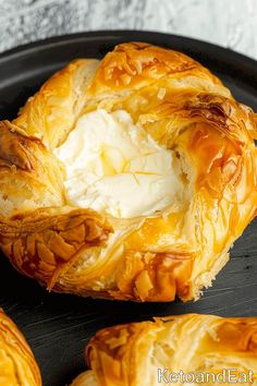 baked pastry with ice cream in it on a black plate