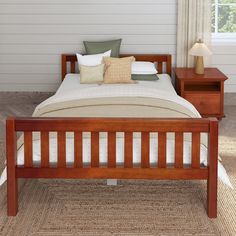 a wooden bed with two night stands next to it