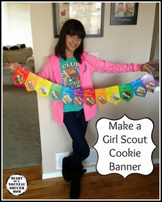 a girl in a pink shirt is holding up some candy bar wrappers with the words make a girl scout cookie banner