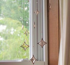 a wind chime hanging from the side of a window