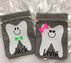 two bags with toothbrushes painted on them, one has a pink bow and the other has a green bow