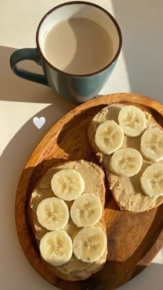 two slices of banana bread on a wooden plate next to a cup of coffee