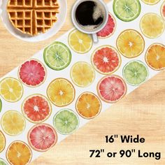 a table with waffles, orange slices and a cup of coffee on it