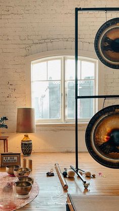 a room filled with lots of musical instruments and other items on the floor next to a window