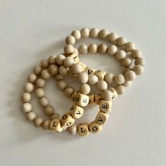 Pick a word to represent your day, your year, your life! Wear your chosen message on your wrist for a gentle nudge. Made of riverstone and wood beads, this bracelet's letters may not always be centered, but that's what adds to its charm! It's perfectly imperfect, just like us. Choose your message Handmade in NYC Gift Wooden Beaded Bracelets, Bohemian Letter Beads Bracelets As Gift, Wooden Name Bracelet, Casual Letter Beads Stretch Bracelet, Inspirational Everyday Bracelets With Letter Beads, Wooden Bead Name Bracelet, Letter Bead Bracelet, Best Gift Cards, Message Bracelet