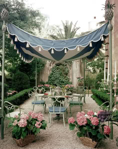 an outdoor dining area with tables and chairs