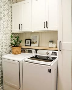 a white washer and dryer sitting next to each other in a laundry room