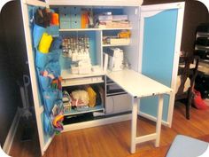 an open cabinet with sewing supplies in it