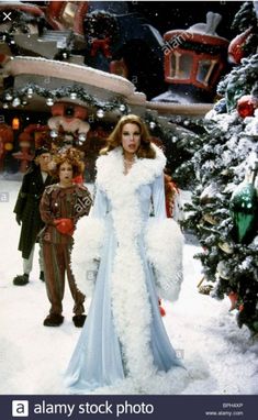 an image of a woman in costume walking through the snow with other people behind her