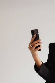 a woman is holding up her cell phone