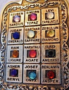 a metal plaque with different colored stones on it