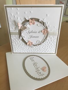 a white card with pink flowers on it