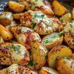 potatoes covered in cheese and seasoning with parmesan sprinkled on top