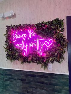 a purple neon sign that says you're like really pretty on the side of a wall