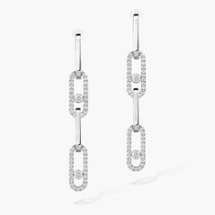 These Move Link diamond earrings in white gold can be transformed to suit any occasion. The bottom part detaches in an instant, allowing you to play with your look: a simple hanging style for everyday wear, a long version for even more sparkle in the evening, or an asymmetrical style for all-out originality. Mix and match, dare to invent your own style. The detachable links will also enhance your neck as a pendant, to be worn on a cord or chain.
 Move Link is a jewelry collection with character: Modern Platinum Diamond Earrings In White Gold, Modern White Gold Linear Earrings With Diamond Accents, Modern White Gold Diamond Drop Earrings, Modern White Gold Diamond Dangle Earrings, Gold And Diamond Earrings, Beyond The Lights, Logo Monogramme, Asymmetrical Style, White Gold Diamond Earrings