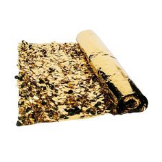 a roll of gold sequins on a white background