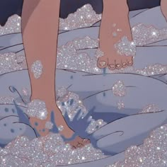 two feet in the sand with glitter on them