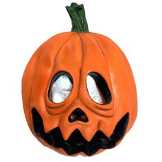 an orange pumpkin with two eyes and a face carved into it's side, on a white background