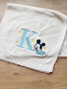 a mickey mouse blanket with the letter k on it's side and an embroidered monogram