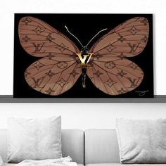 a living room with a couch and large butterfly on the wall