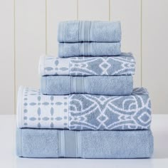 four blue towels stacked on top of each other