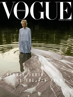 a woman standing in the water on top of a magazine cover with an image of a bird