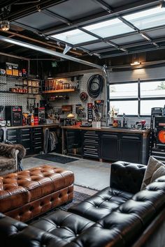 a garage with lots of black furniture and shelves on the wall, including two leather couches