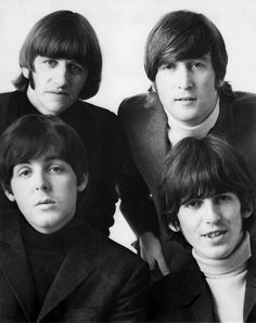 the beatles are posing for a photo in black and white