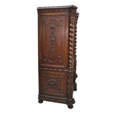 an old wooden cabinet with carvings on the front and side panels, in brown wood