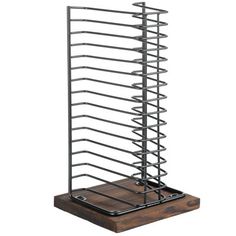 a metal rack with several racks on it and a wooden board in front of it