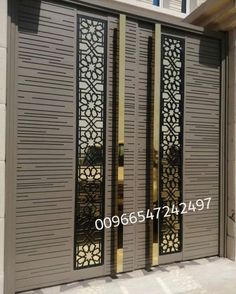 an iron gate with decorative designs on the sides and side panels, in front of a house