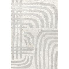 a white and gray rug with wavy lines on the bottom, in an abstract pattern