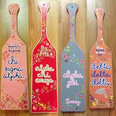 three wine bottle shaped magnets with flowers on them