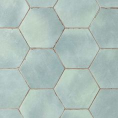 a tile floor with hexagonal tiles in light blue and white colors on it