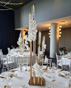 a tall centerpiece with white flowers and candles