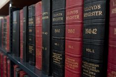 rows of red and black books on a shelf