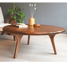 a wooden table sitting on top of a hard wood floor next to a white chair