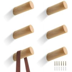 four wooden pegs and two brown ribbon