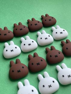 chocolate bunnies are arranged in the shape of bunny ears on a green tablecloth