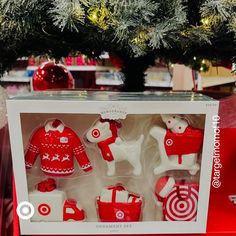 a christmas ornament set in a box next to a tree